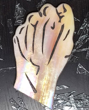 Stained glass fist with layered tinned illustrations that make it look like the back of a hand.