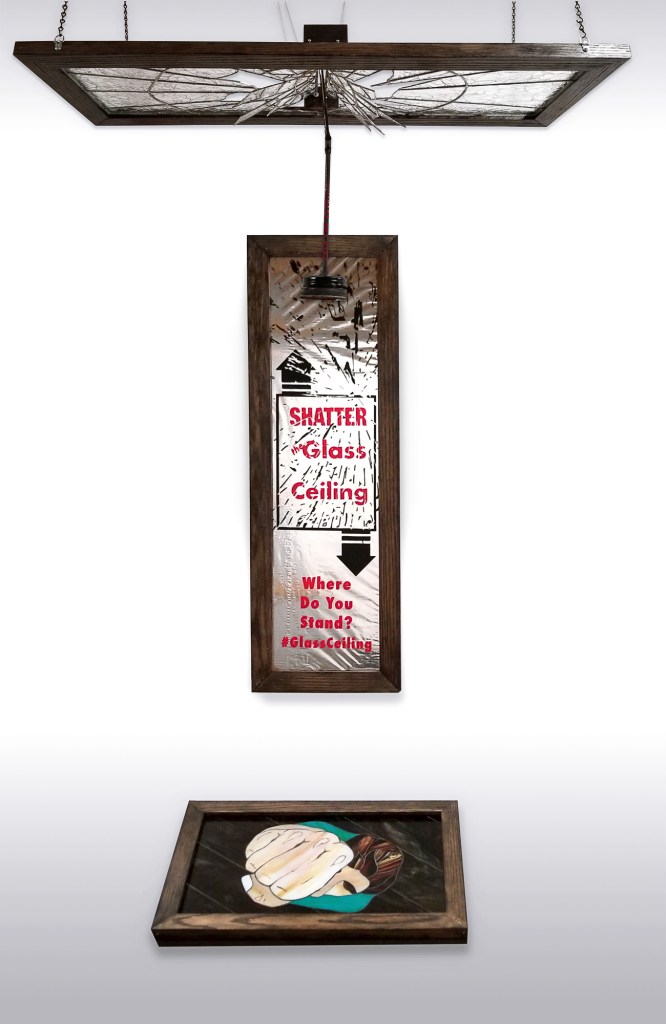 Triptych work of art, Where Do You Stand? A glass mobile of a window you can break, a graphic of glass breaking questioning where you stand, a mosaic on the floor of someone punching up to shatter the glass window